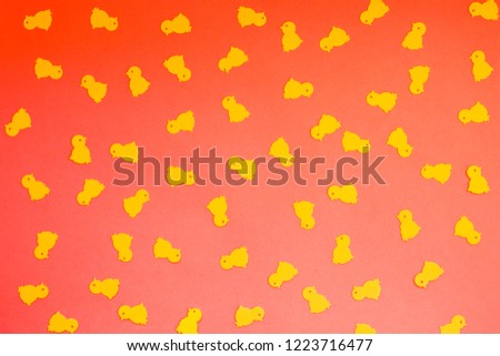 Yellow chickens on a red orange background, Easter concept