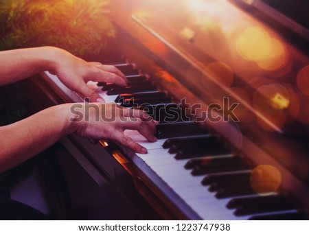 close up of a young man hands on piano keys with Bokeh light , Christmas night with copy space