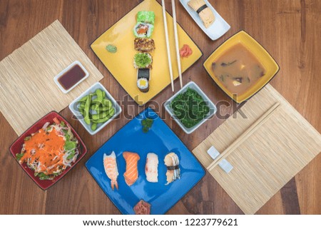 Japaneese food: dishes with sushis, maki, miso soup, wakame  salad and edamame
