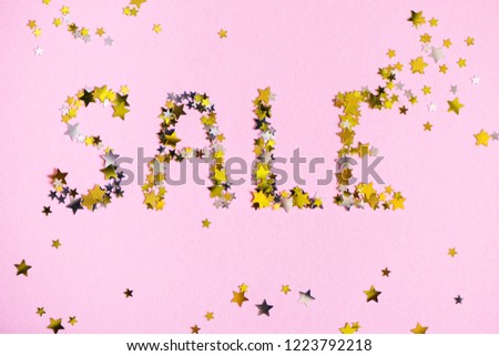 Word SALE made of many gold stars on pink background