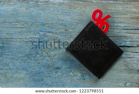  leather wallet with sign percent on wooden background. Top view.
