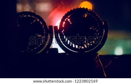 Two small fans on a dashboard of a car unique photo