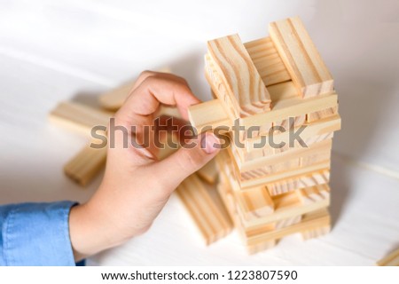 Planning and strategy of project management in business, businessmen and gambling engineers, placing a wooden block on the tower. The concept of business and construction.