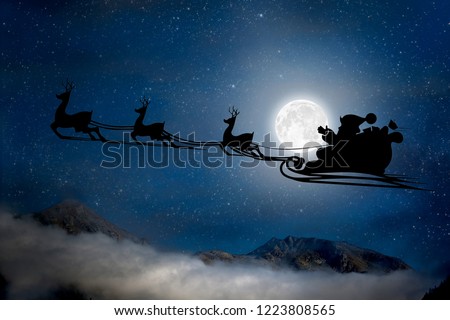 silhouette of a flying goth santa claus against the background of the christmas night sky. Elements of this image furnished by NASA