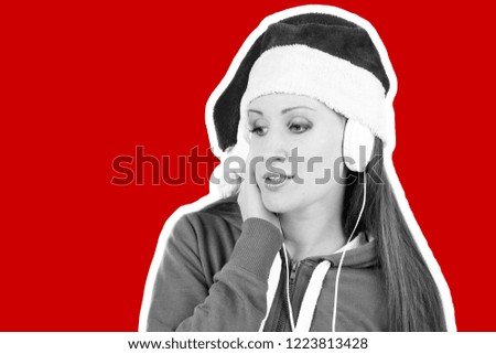 Attractive smiling young girl dressed in Santa's hat listening the music by headphones. Christmas and New Year advertising concept. Magazine style fashion collage