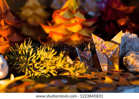 A fox with her puppy in a beautiful fall origami forest