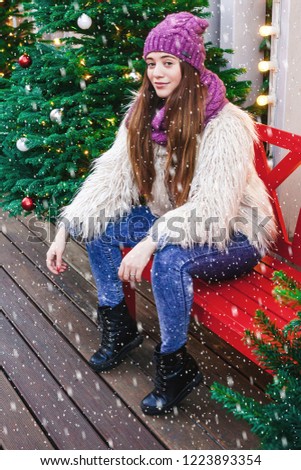 Young beautiful fashion girl is having fun  through winter holiday in Christmas, Moscow