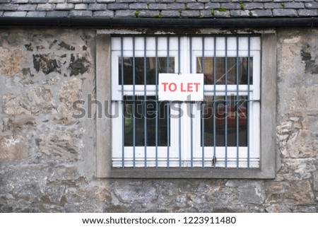 Property to let rent sign in window of building