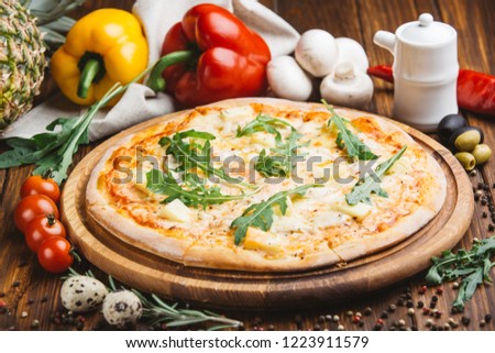 Hawaiian pizza on wooden plate