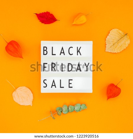 Creative Top view flat lay promotion composition Black friday sale text on white lightbox leaves orange background copy space Square Template Black friday sale mockup fall thanksgiving advertising