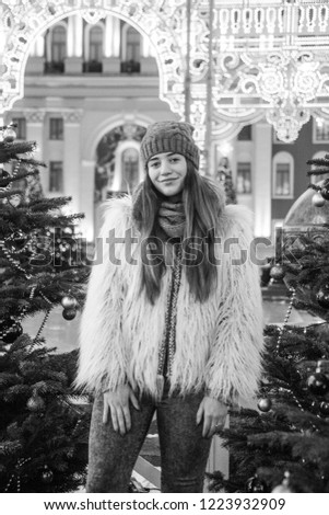 Young beautiful fashion girl is having fun  through winter holiday in Christmas, Moscow, black and white photos