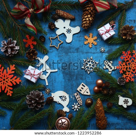 christmas and new year card with tree decorations/wooden figures of houses,snowflakes on the blue rustic background