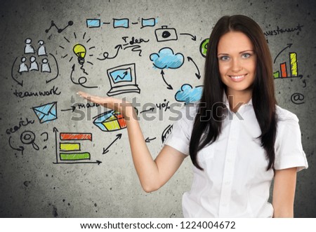 Smiling pretty woman holding finger on face and business signs