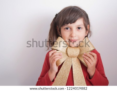 Christmas gift girl with golden bow on her neck