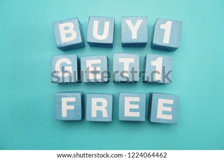 Buy 1 Get 1 Free created with cubes on blue background