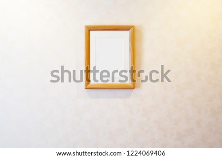 Blank wooden picture frame on the wall, rectangular photo frame with shadow