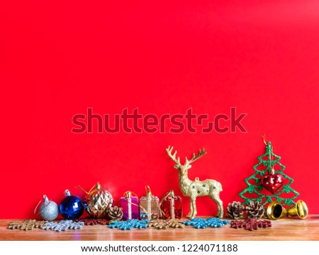 Christmas  decoration  with  ornament  on  wooden  surface  with  red  background