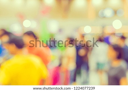 Vintage tone abstract blur image of People walking at shopping mall with bokeh for background usage .