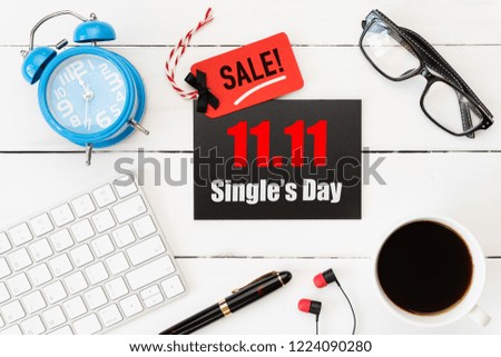 Online shopping of China, 11.11 single day sale concept. Red and black ticket with coffee cup, keyboard computer and mouse on white wooden background. Shopping concept.