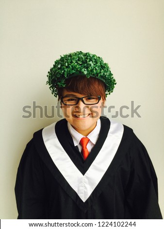 Happy university graduates with funny grass hat 
