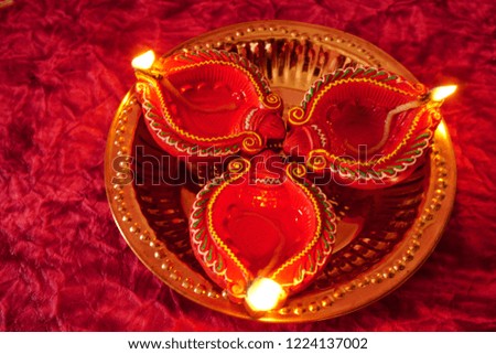 Clay diya lamps lit during Diwali Celebration. Greetings Card Design Indian Hindu Light Festival called Diwali                