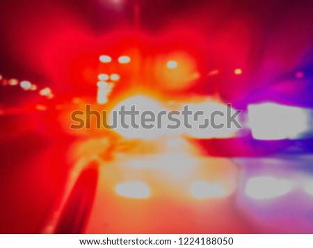 Red and blue Lights of police car in night time, crime scene. Night patrolling the city. Abstract blurry image.