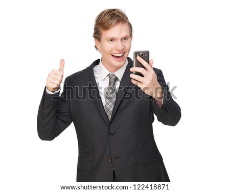 Business man with thumbs up. Looking at phone and smiling. Isolated on white background