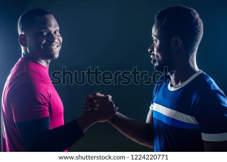 team work two handsome african american sportsman in boxing on a black background in the gym,trainer and ward practicing boxing