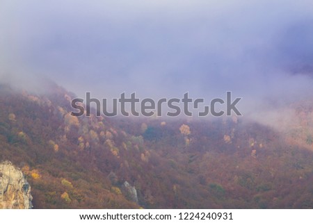 Autumn colors and morning mist in remote mountains in Europe