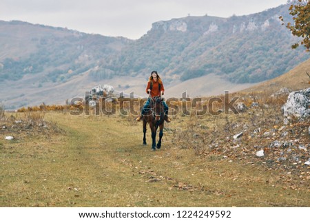 happy woman on horseback on nature tourism travel                          
