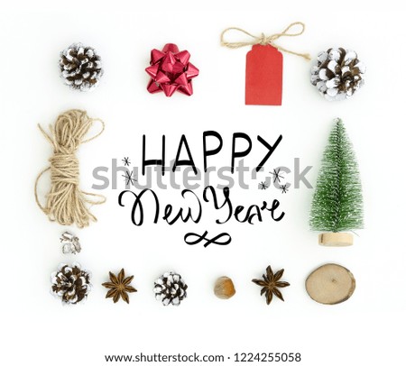 New Year greeting card . White ackground with hand lettering composition Happy New Year in frame of chtistmas tree toys, anise stars, fir cones, rope. Flat lay, top view of New Year 2019
