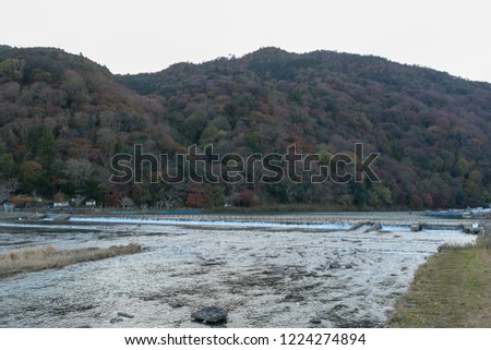 Hozu-gawa River with Autumn tree in mountain background at arashiyama Kyoto Japan.