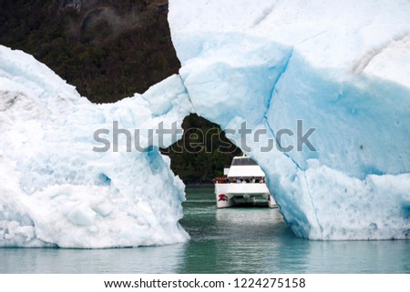Sailing between icebergs floating in the water
