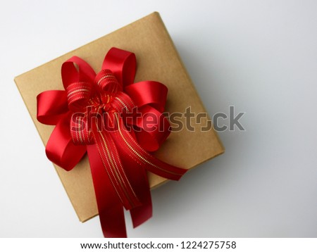 Top view on composition space over red ribbon bow gift box for season greeting concept