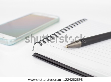 close up black pen on Notebook paper,object on White background