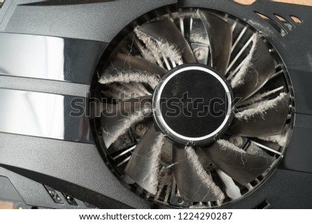 Closeup of dusty computer graphics card fan.