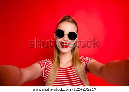 Self-portrait of nice cute cool lovely glamorous attractive winsome fasionable girl in round glasses isolated over bright vivid red background