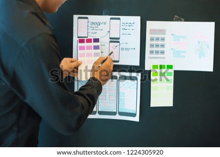 Young designers are choosing color scheme for mobile application design.