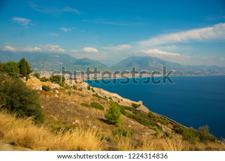 Top view from the fortress of Alanya on the blue sea, the fortifications and the city. Alanya, Antalya district, Turkey, Asia