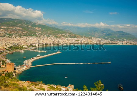 Top view of the city: the blue sea, mountains, lighthouse, walls and port. Alanya, Antalya district, Turkey