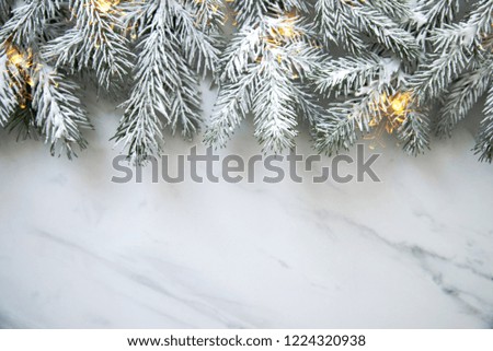 Christmas background with xmas tree on white marble background. Merry Christmas greeting card, frame, banner. Winter holiday theme. Happy New Year. Noel. Space for text. Flat lay