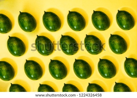green lemons on yellow pastel background, concepts,summer ideas of fruit, vegetable, healthy eating lifestyle, flat lay,