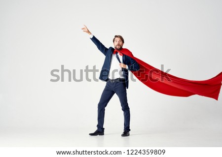 a man in a red coat with his hand raised                   