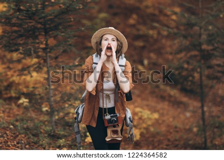 Fashion look, pretty cool young woman model with retro film camera wearing a elegant hat