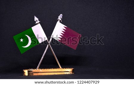 Pakistan and Qatar table flag with black Background