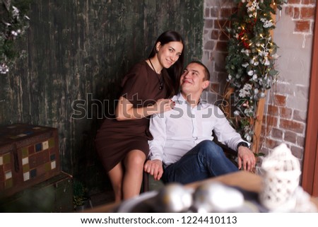 Beautiful couple in Christmas interior studio.