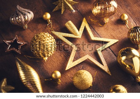 Christmas background. Set with a lot of different gold vintage baubles and stars over dark wooden board. Christmas preparation concept