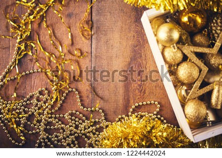 Christmas background. a lot of different gold  bauble and decorations  over dark wooden board. Christmas preparation concept
