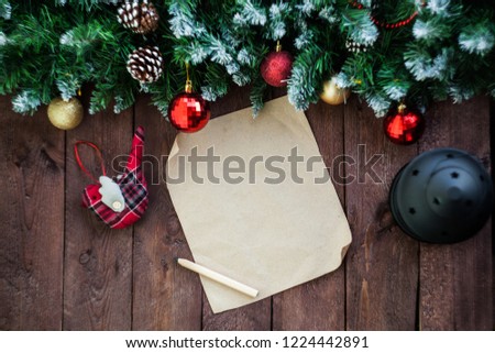 Christmas background, an empty wish list for Santa Claus on a brown wooden table. New Year's decor, fir branches.copy space