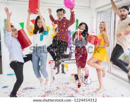 group of friends celebrate party and  throwing confetti while enjoying home party